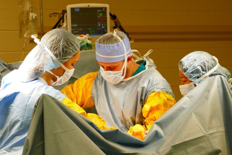 ER 3 (From left) Emily Schaefer, Bruno Malacarne, and Akane Someya during surgery at EMC.