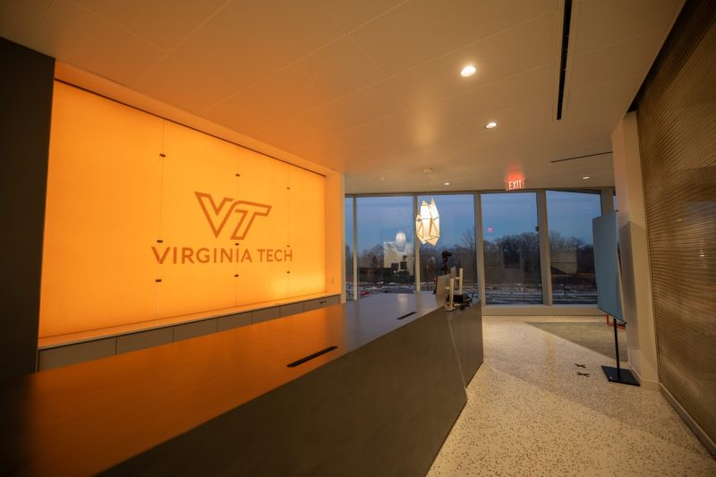 a room with a long island and a bright orange Virginia Tech sign behind it