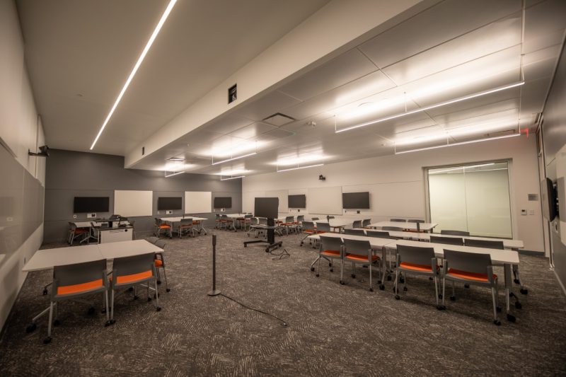 a classroom with orange seating and long tables