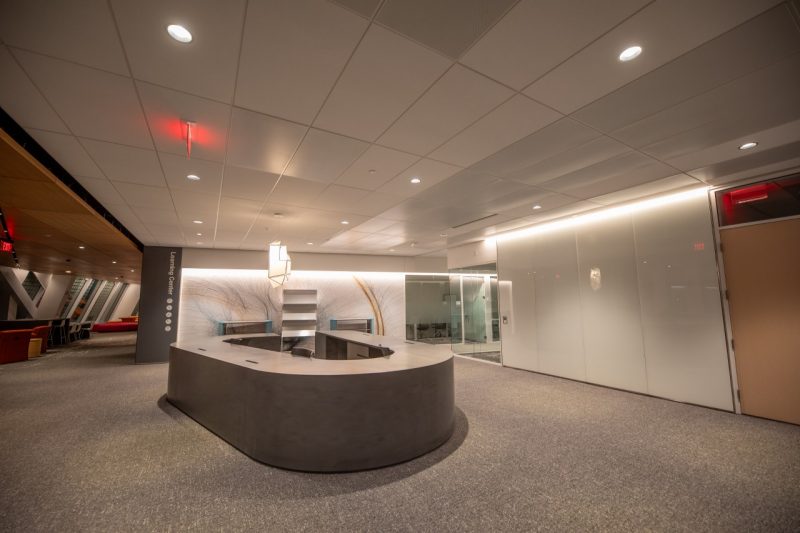 an office space with a round desk in the middle of the room