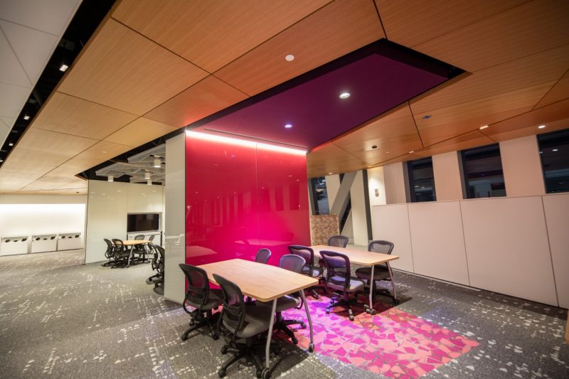 interior of a room with bright,angular ceilings and office furniture