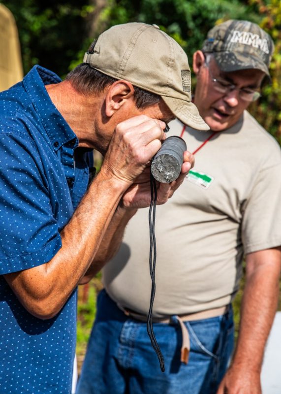 A researcher inspecting a drill core sample.