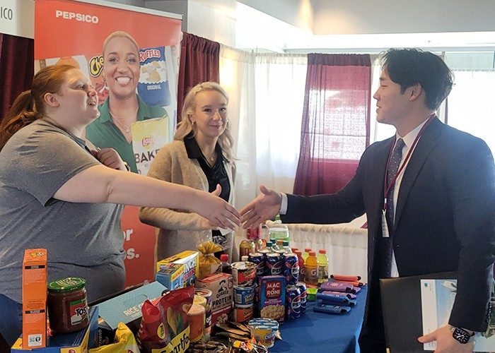 Meet and greet Representatives from PepsiCo speaking with a graduate student, Young-Ju Eun