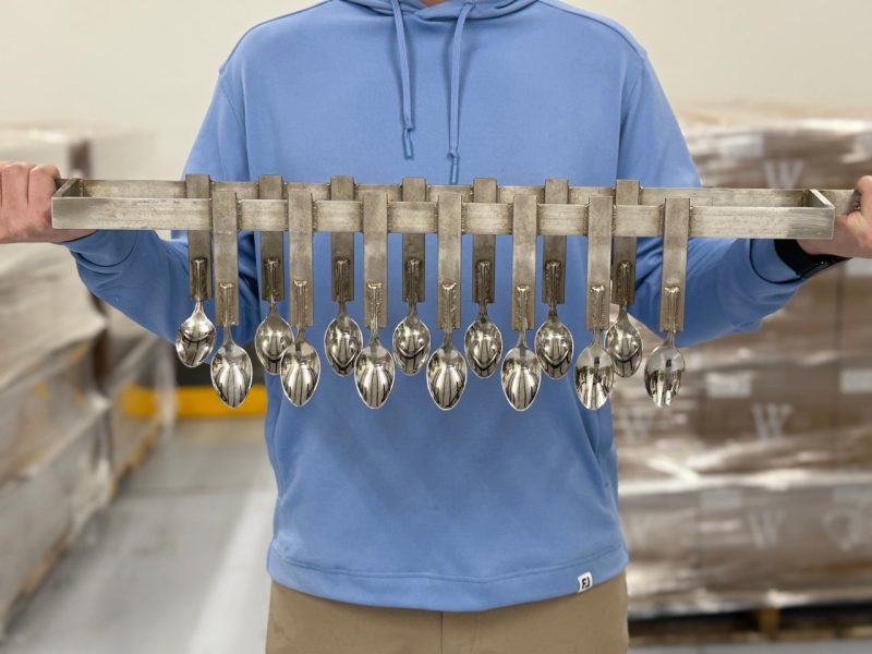 A person holds old machinery.