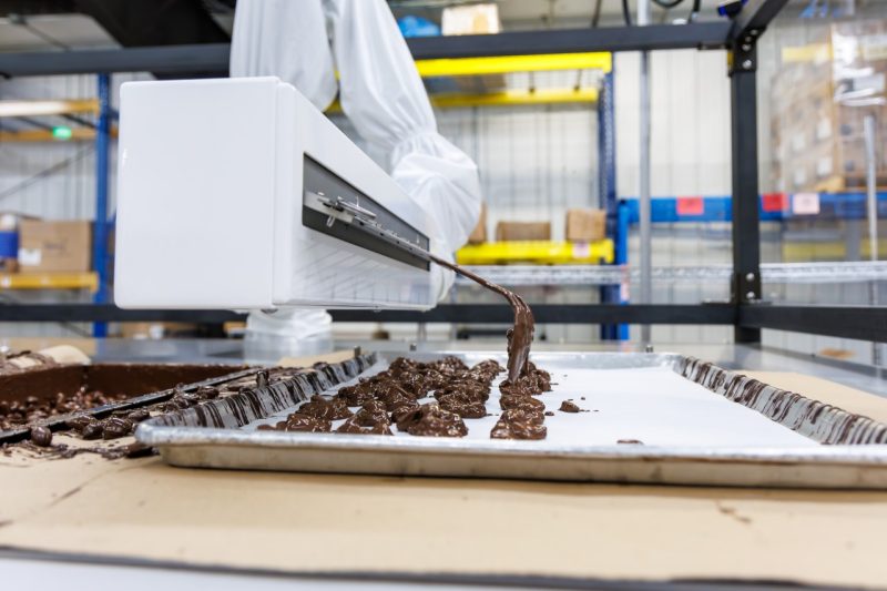 A robot serves chocolate candy.