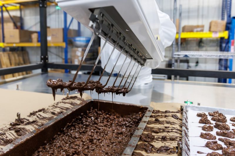 A robot serves chocolate candy.