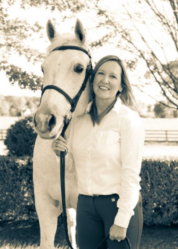 Melody Meehan Melody Meehan stand beside her trail horse.