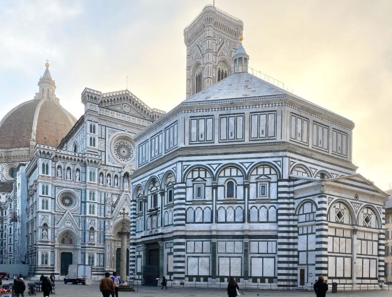Florence Baptistery Exterior view of the Florence Baptistery, an octagonal building with white and green marble panels, featuring Romanesque architecture and a tiled dome.