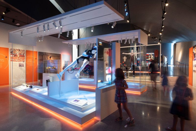 U.S. Olympic and Paralympic Museum A section of a museum, the key area being a speed skating figurine in a large, glass-walled display.
