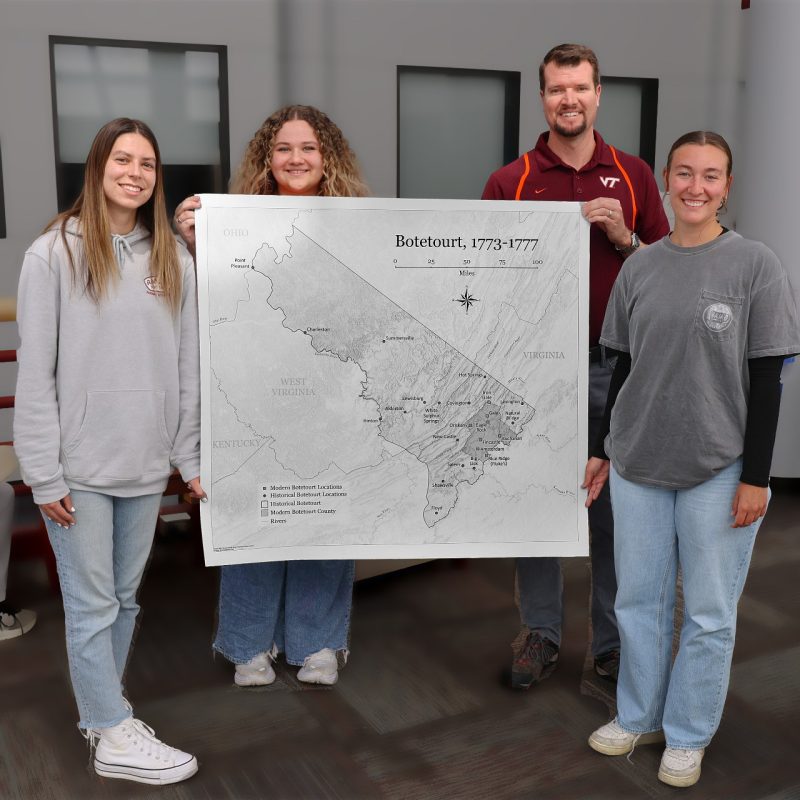 Cartography TAs and Botetourt map Hannah Crook (far left), Emma Dilic (middle left), and Sarah Cohoon (far right) are undergraduate teaching assistants in Senior Instructor Stewart Scales' (middle right) cartography class. When the Botetourt County Historical Society needed a map of the county in 1775, the TAs were tasked with its creation. It was presented to the society in March.