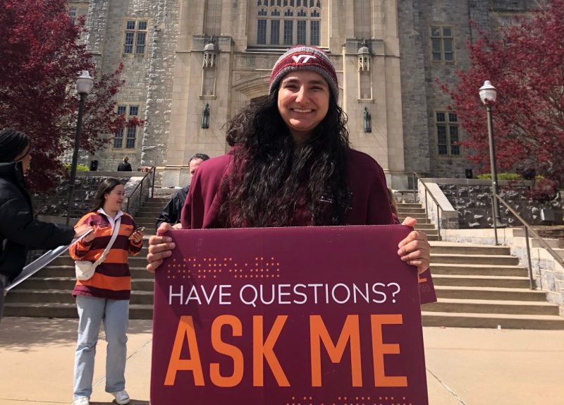 Omara holds up as sign inviting people to ask her questions