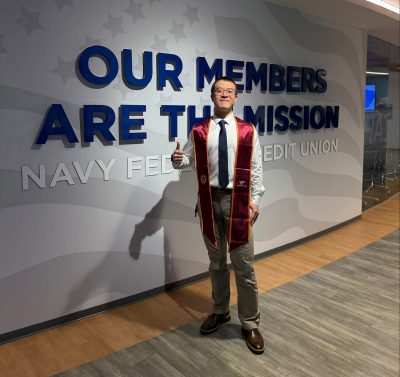 Baiyi Zhang in front of the Navy Federal Credit Union sign