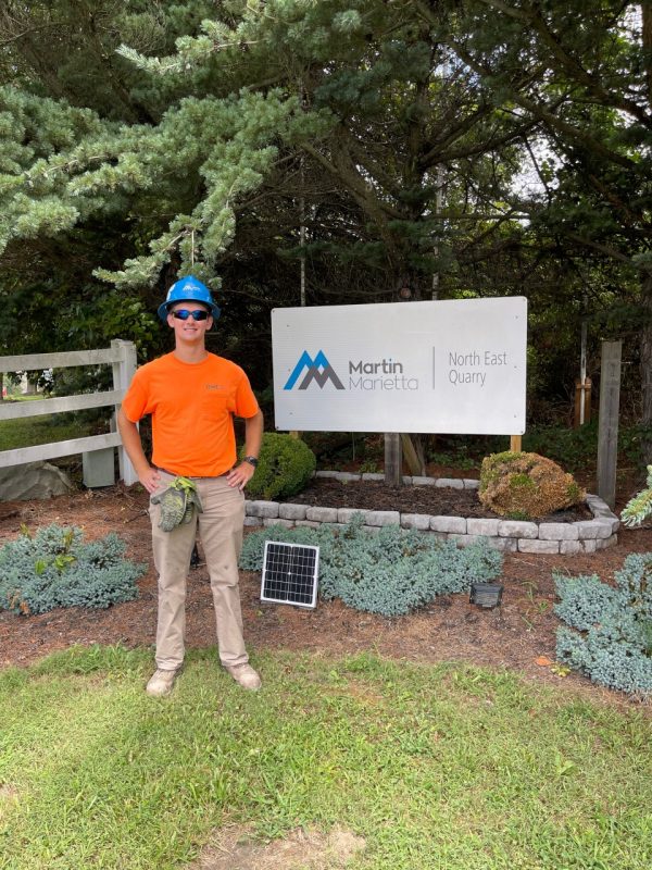 Student stands in front of internship.