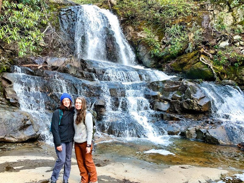 Mary Grace Larson and Maia Caddle in Great Smoky Mountains NP Graduate students Mary Grace Larson (left) and Maia Caddle hiked to a waterfall in the Great Smoky Mountains National Park as part of their research about programs offered by the National Park Service.