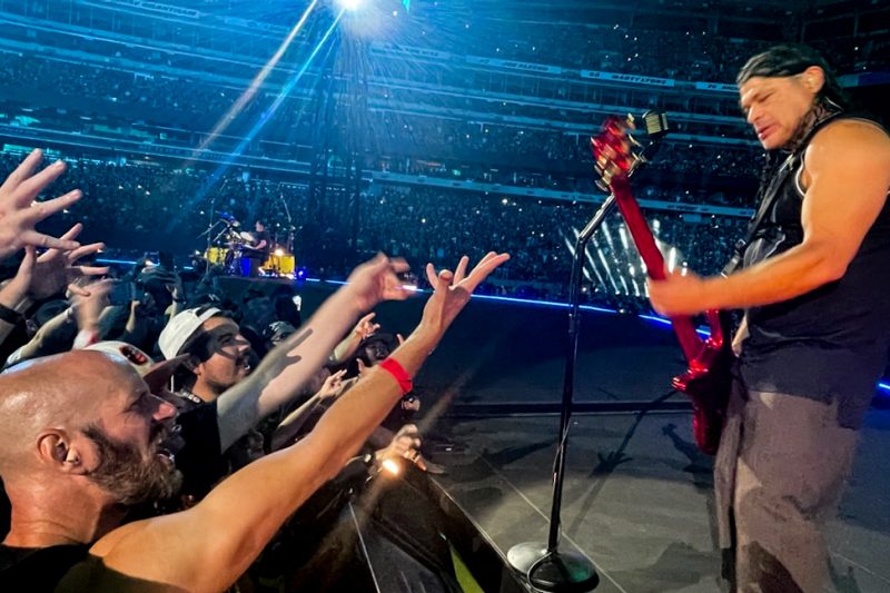 George Probst reaching over the stage at a Metallica concert