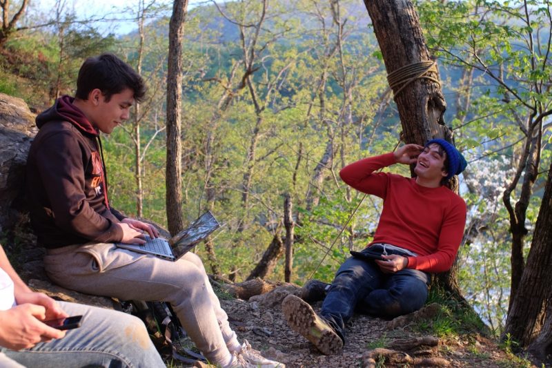 Three guys resting after hiking in the woods