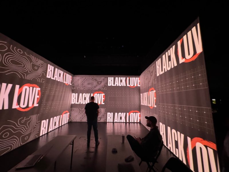 Black background with white words "Black Love" and two men surrounded by the words.