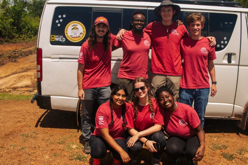 Students stand in front of van during an Engineering Without Borders trip to Kenya