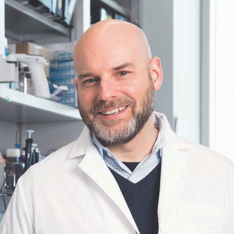 Memorial Sloan Kettering Annual 2017 man in lab coat with equipment on shelves in background