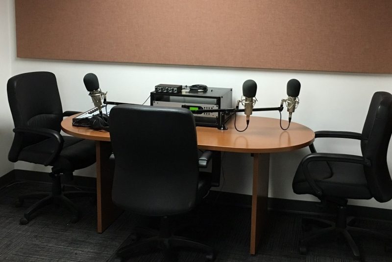 radio broadcast equipment, microphones, table and chairs