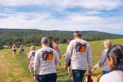 People hiking a trail wearing Hokie Hike branded shirts