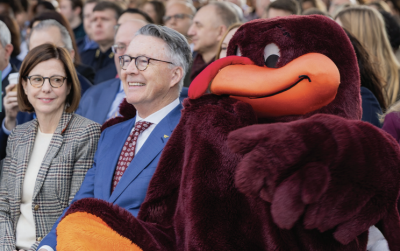 Dr. Laura Sands, President Tim Sands, and HokieBird at the grand opening celebration for the Innovation Campus Academic Building One in Alexandria, Virginia