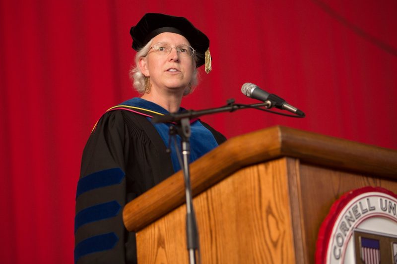 Barbara Knuth A woman wearing academic regalia standing at a podium that reads Cornell University.