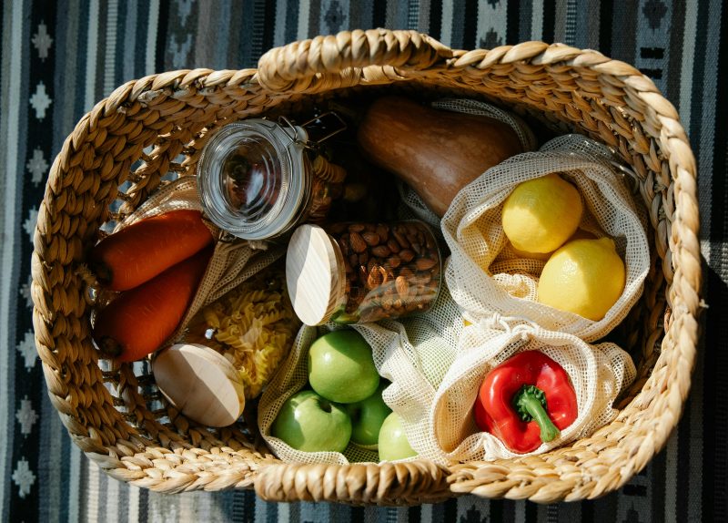 Photo of strraw basket with fruit and vegetables
