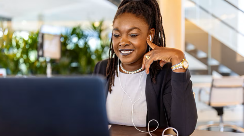 Photo of a woman in front of a laptop computer.