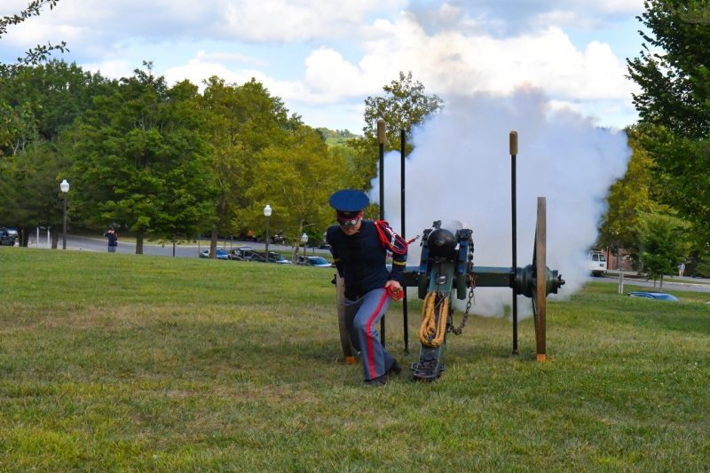 a cadet fires Skipper from the lawn in front of Pearson Hall East on upper quad