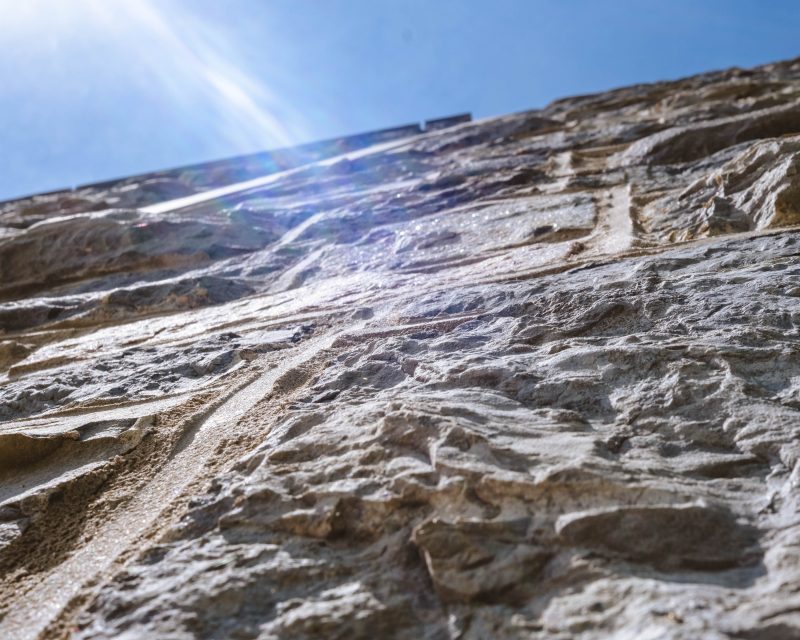 Sun shines on a grey Hokie Stone wall