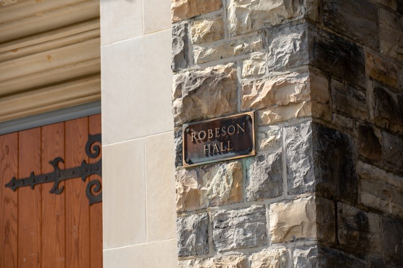 Grey Hokie Stone building with signage reading "Robeson Hall." 