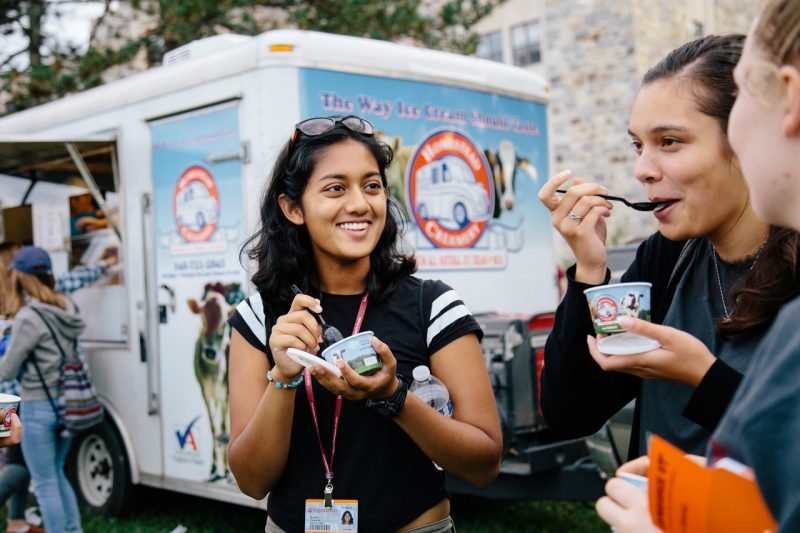 image shows students eating cups of ice cream.