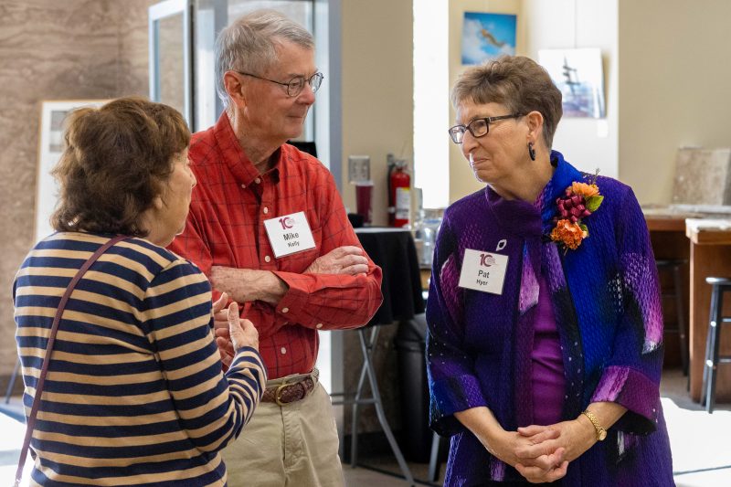 Pat Hyer talking with two people